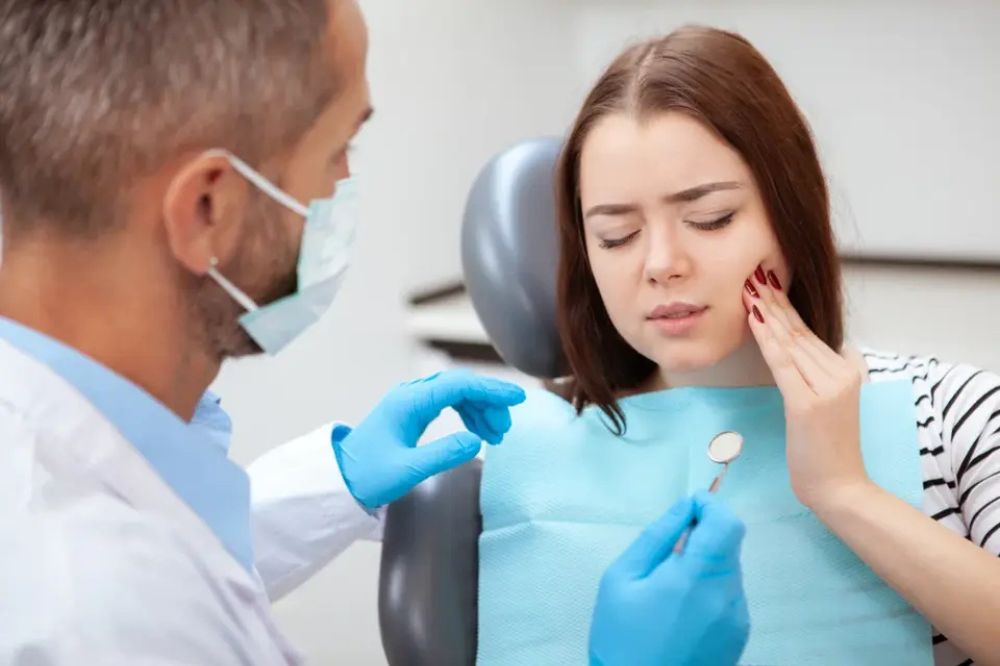 a woman is getting dental treatment