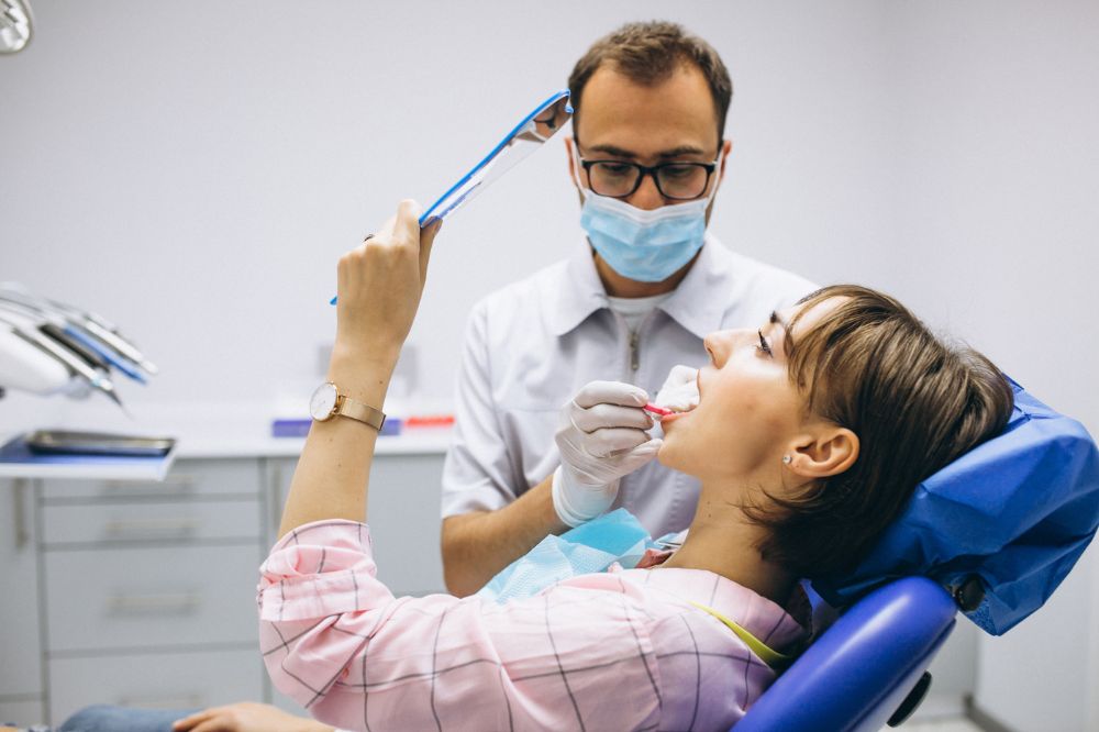 a woman is getting dental treatment