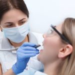 a woman is getting dental treatment