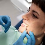 a woman is getting dental treatment